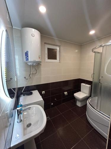 a bathroom with a sink and a toilet at Green Villa Sea View in Gonio