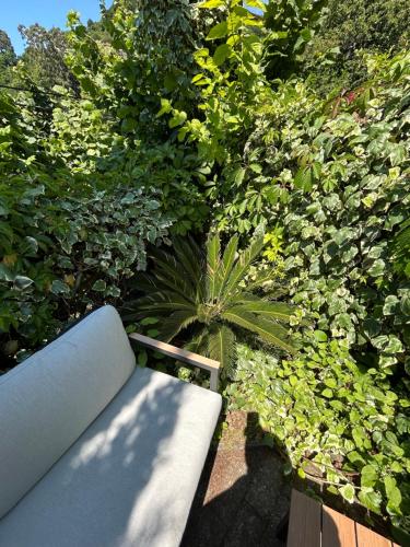 a blue bench sitting in front of some bushes at Green Villa Sea View in Gonio