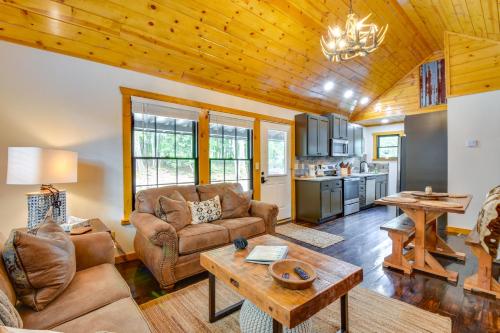 a living room with a couch and a table at 6 Mi to Helen Mtn-View Retreat with Hot Tub! in Clarkesville