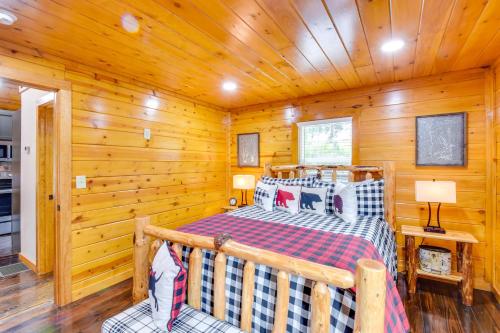 a bedroom with a bed in a log cabin at 6 Mi to Helen Mtn-View Retreat with Hot Tub! in Clarkesville