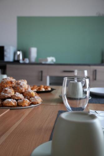 a table with two plates of pastries and a glass at Agriturismo La Fornetta in Ferrara