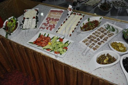 a table with many plates of food on it at Kivrak Hotel in Antalya