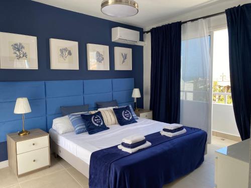 a blue bedroom with a large bed with blue walls at Malibu Park Apartment Mar Azul in Adeje