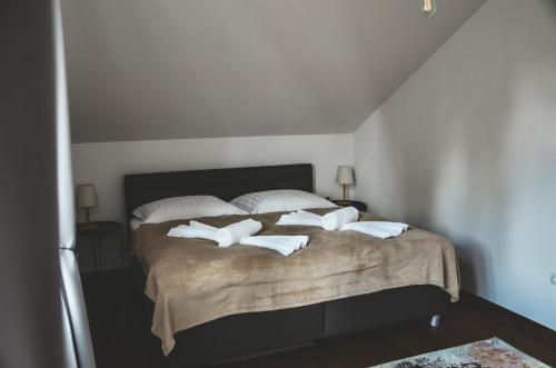 a bedroom with a large bed with white pillows at Apartmány Švejdom dom, centrum Bojnice in Bojnice