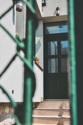 a front door of a house with stairs and plants at Apartmány Švejdom dom, centrum Bojnice in Bojnice