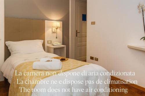 a hotel room with a bed with a towel at Hotel Villa Maria in Sanremo