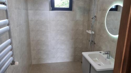 a bathroom with a sink and a mirror at Chic 3-room apartment in K'obulet'i