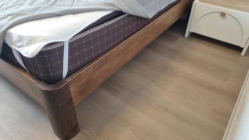 a bedroom with a bed with a wooden floor at Chic 3-room apartment in K'obulet'i