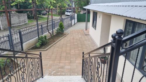 a balcony with a gate and a brick walkway at Chic 3-room apartment in K'obulet'i