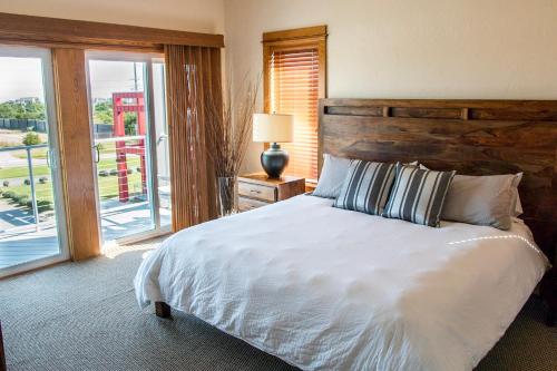 a bedroom with a bed and a large window at The Boiler - 3-Bedroom, 3-Bathroom Penthouse Suite at REAL Watersports in Waves