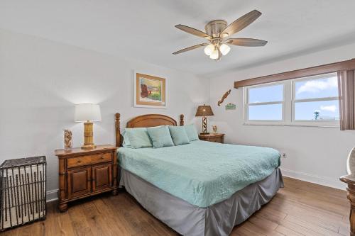 a bedroom with a bed and a ceiling fan at 404 - 2/2 Ocean View Escape in New Smyrna Beach