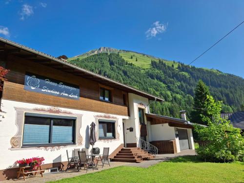 a guest house with a mountain in the background at Haus Sprenger in Häselgehr