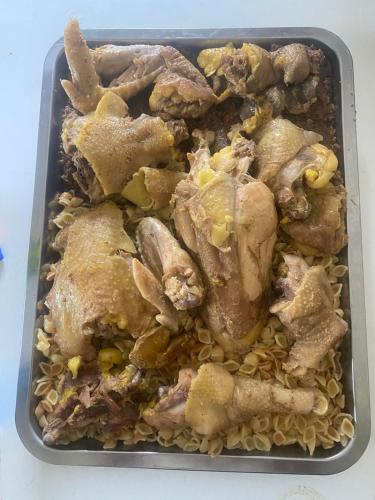 a tray of food with chicken and rice at Sylbica in Polisi i Vogël