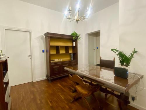 a dining room with a table with a laptop on it at Helios Home in Reggio Calabria