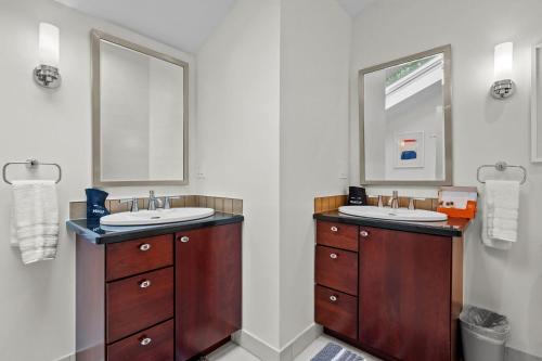 a bathroom with two sinks and two mirrors at 1010 Rosehill Dr in Boulder