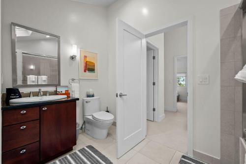 a bathroom with a toilet and a sink and a mirror at 1010 Rosehill Dr in Boulder