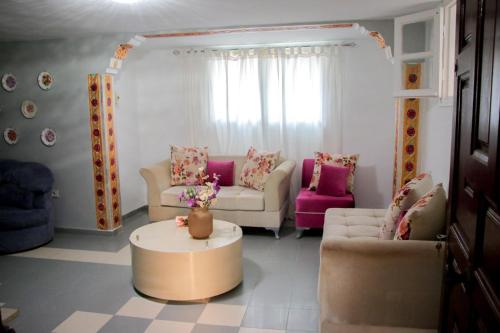 a living room with two couches and a coffee table at Maisonabdou in Sousse