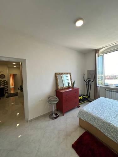 a bedroom with a bed and a dresser and a window at Siffredi Rooms in Genova