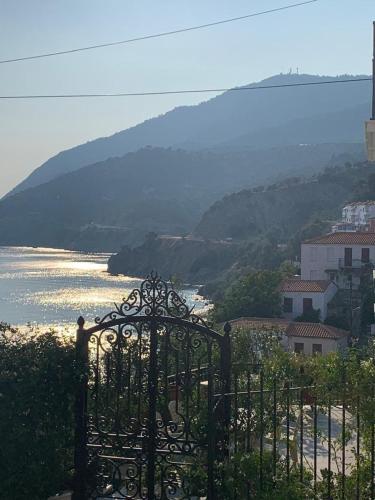 a gate with a view of a body of water at Captain's House in Plomarion