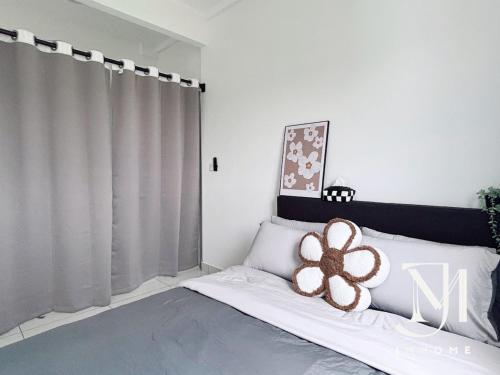 a bedroom with a bed with a flower on it at C180 Family Suite Trader Park #22 in Cheras