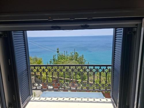 a view of the ocean from a window at Captain's House in Plomarion
