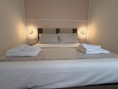 a bedroom with a large bed with towels on it at Il Leccio Verde in Lecce