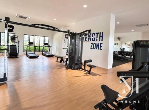 a gym with treadmills and machines in a room at C180 Family Suite Trader Park #22 in Cheras