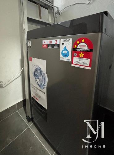 a refrigerator in a room with signs on it at C180 Family Suite Trader Park #22 in Cheras
