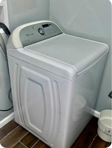 a white washer and dryer in a room at Luxurious, Spacious, Modern 6 BR Escape with parkings and sleeps up to 16 in Irvington