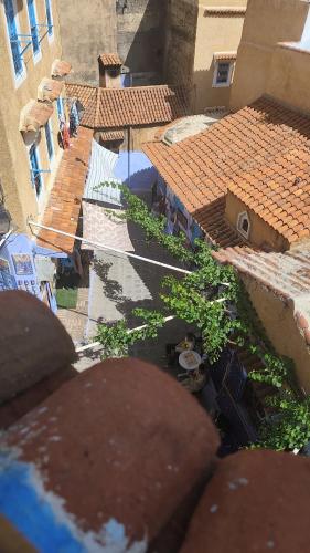 an overhead view of roofs of buildings and trees at Maison de vacances 3 chambres en Medina in Chefchaouene