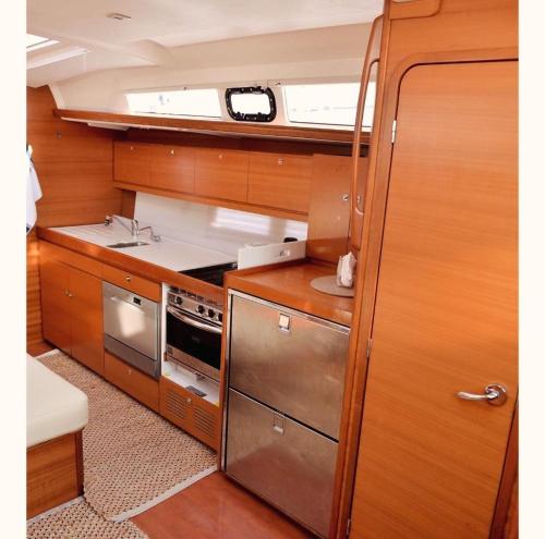 a small kitchen with a sink and a stove at Adriatic Blue Voyage in Tivat