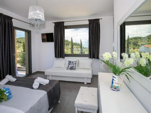 a bedroom with two beds and a living room at Astris Sun Hotel in Astris