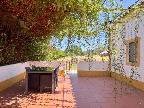 a patio with a table and a fence at Quinta Casa Seleiras in Évora