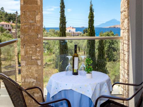 a table with a bottle of wine and a glass at Astris Sun Hotel in Astris