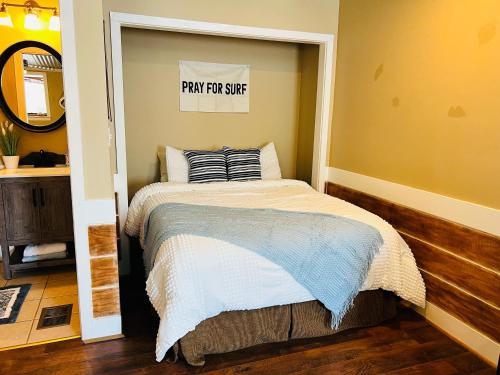 a bedroom with a bed with a play forsie sign on the wall at The Beach Comber in Canton