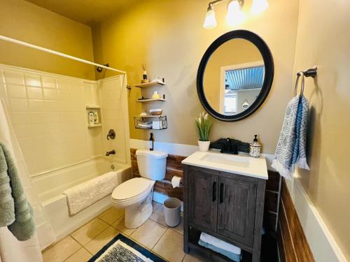 a bathroom with a sink and a toilet and a mirror at The Beach Comber in Canton