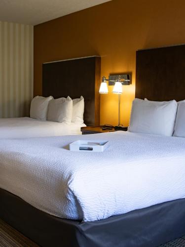 a hotel room with two beds and two lamps at Prestige Prince George Lodge in Prince George