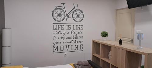 a living room with a bike on the wall at Anna's House in Bük