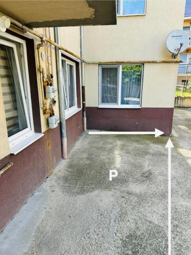 a parking lot in front of a building at Cozy BBC Apartment in Cluj-Napoca