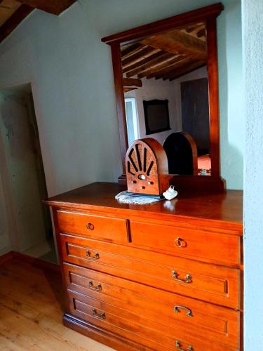 a dresser with a mirror on top of it at Da Nonno in Montegiovi