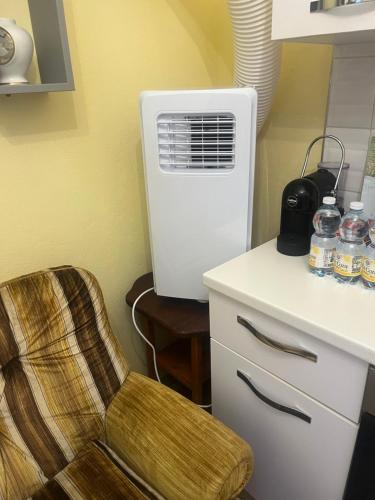a room with a chair and an air conditioner at La casa di RO in Uscio