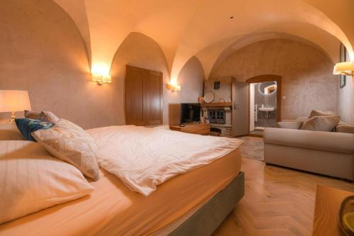 a large bedroom with a large bed and a couch at Vila Zipser in Poprad