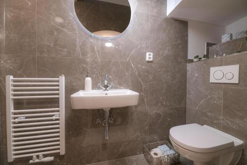 a bathroom with a sink and a toilet at Vila Zipser in Poprad