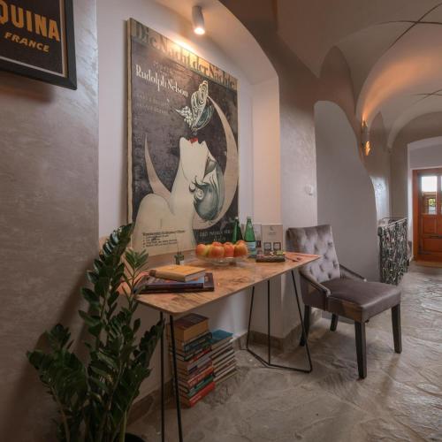 a table in a room with a picture of a cat on the wall at Vila Zipser in Poprad
