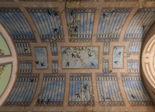 a ceiling in a building with paintings on it at Palazzo Caputo in Nardò