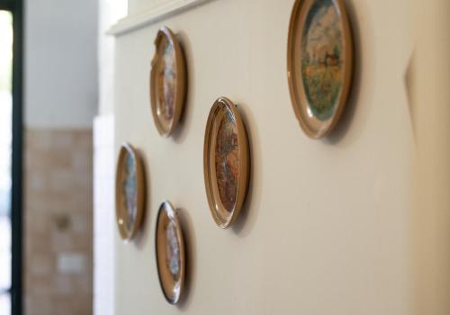 a group of clocks hanging on a wall at Palazzo Caputo in Nardò