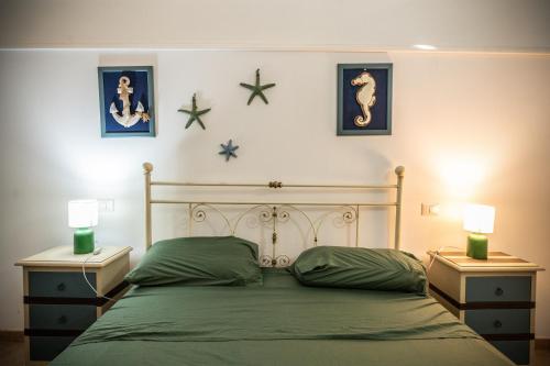 a bedroom with a bed with two night stands and two lamps at Palazzo Caputo in Nardò