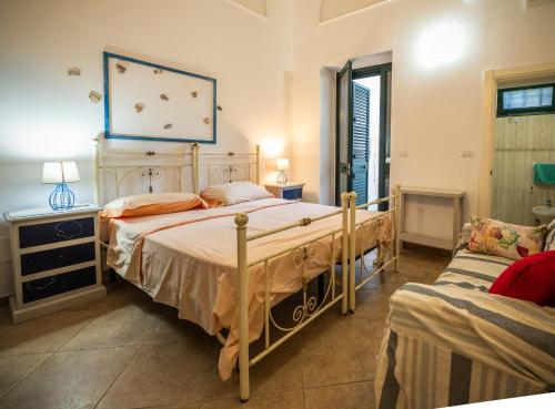 a bedroom with a large bed and a couch at Palazzo Caputo in Nardò