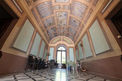 a room with a ceiling with windows and chairs at Palazzo Caputo in Nardò
