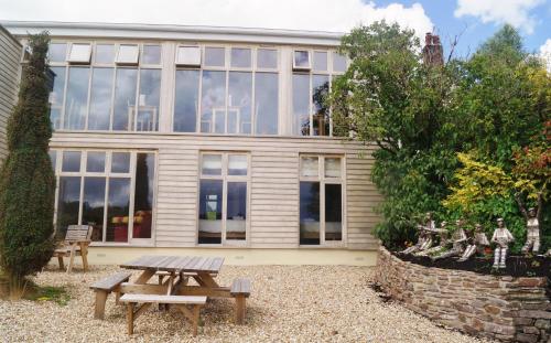 a house with a picnic table in front of it at The Poltimore Inn in North Molton